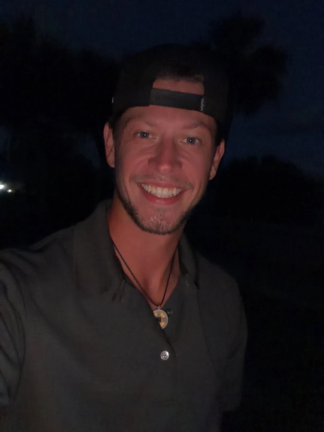 Kadin smiling in a backwards cap at dusk, fresh off the golf course